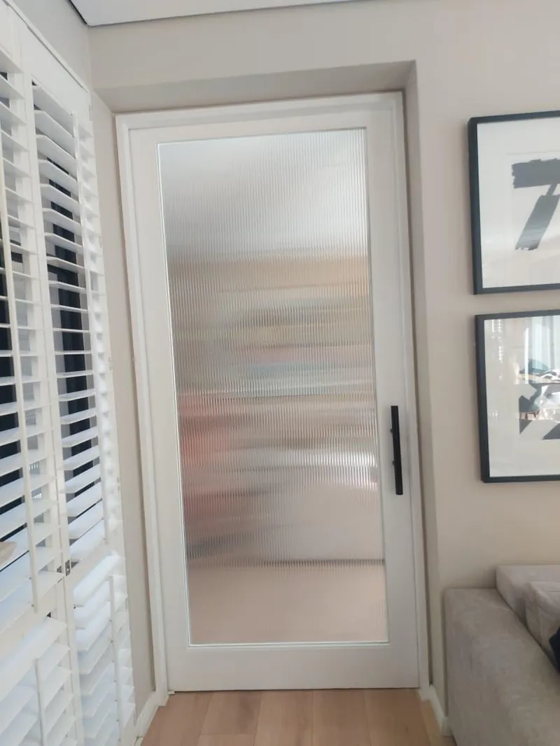 Reeded fluted glass effect Nanoshade window film installed on interior door, trending modern privacy solution